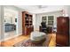 Well-lit home office with hardwood floors, custom built-ins, and a comfortable workspace at 1884 Whitehawk Ct, Lawrenceville, GA 30043