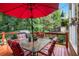 Spacious deck with a table, chairs, umbrella, and a barbecue grill, perfect for outdoor entertaining at 1884 Whitehawk Ct, Lawrenceville, GA 30043