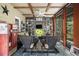 Charming screened porch with Coca-Cola machine, seating, and decor at 1884 Whitehawk Ct, Lawrenceville, GA 30043