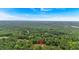 Aerial view of a home surrounded by lush green trees in a serene setting at 3088 Hiram Sudie Road, Hiram, GA 30141