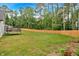 Expansive backyard featuring a trampoline and a wooden privacy fence, ideal for outdoor activities at 3088 Hiram Sudie Road, Hiram, GA 30141
