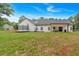 Expansive backyard featuring a well-maintained lawn and white farmhouse-style house with black trim at 3088 Hiram Sudie Road, Hiram, GA 30141