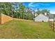 Spacious backyard featuring a new wooden fence, lush lawn, and view of the home's exterior at 3088 Hiram Sudie Road, Hiram, GA 30141