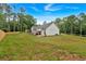 Spacious backyard with a partial wooden fence, green lawn, and view of the home's exterior at 3088 Hiram Sudie Road, Hiram, GA 30141