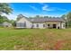 Expansive backyard featuring a trampoline, lush lawn, and a modern white farmhouse-style home at 3088 Hiram Sudie Road, Hiram, GA 30141