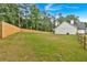 A fenced-in backyard featuring a large lawn and partially visible house exterior at 3088 Hiram Sudie Road, Hiram, GA 30141
