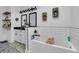 Bright bathroom featuring subway tile, a soaking tub, and modern fixtures at 3088 Hiram Sudie Road, Hiram, GA 30141