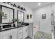 A bright bathroom features double mirrors, modern lights, and a walk-in shower at 3088 Hiram Sudie Road, Hiram, GA 30141