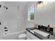 A bright bathroom with modern fixtures and an updated shower/tub combo at 3088 Hiram Sudie Road, Hiram, GA 30141