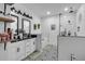 Modern bathroom with a glass shower, tub, double vanity, and stylish black and white floor at 3088 Hiram Sudie Road, Hiram, GA 30141