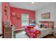 A bedroom featuring pink walls, white trim, and unique decor and furnishings at 3088 Hiram Sudie Road, Hiram, GA 30141