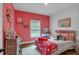 Bright bedroom with pink accent wall, white shiplap, and cozy decor at 3088 Hiram Sudie Road, Hiram, GA 30141