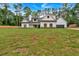 Charming two-story white farmhouse with black trim and wood shutters surrounded by a huge green lawn at 3088 Hiram Sudie Road, Hiram, GA 30141