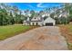 Two-story white farmhouse with black trim, dark roof, wood shutters and a gravel driveway at 3088 Hiram Sudie Road, Hiram, GA 30141