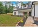 Charming two-story white farmhouse with covered porch and landscaping at front entrance at 3088 Hiram Sudie Road, Hiram, GA 30141