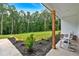 Inviting covered front porch with landscaping with two white rocking chairs at 3088 Hiram Sudie Road, Hiram, GA 30141
