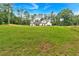 Two-story white farmhouse with black trim and wood shutters surrounded by a large green lawn at 3088 Hiram Sudie Road, Hiram, GA 30141