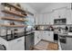 Contemporary kitchen with stainless appliances, floating shelves and farmhouse sink at 3088 Hiram Sudie Road, Hiram, GA 30141