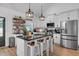 Modern kitchen with stainless steel appliances, island seating, and open shelving at 3088 Hiram Sudie Road, Hiram, GA 30141