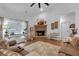 Bright living room showcasing a brick fireplace and a large window for natural light at 3088 Hiram Sudie Road, Hiram, GA 30141