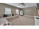 A cozy carpeted living room with a sectional couch, white trim, and neutral walls at 3088 Hiram Sudie Road, Hiram, GA 30141