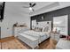Stylish main bedroom with a decorative accent wall, tray ceiling, and ample natural light at 3088 Hiram Sudie Road, Hiram, GA 30141