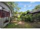 The fenced backyard has a small deck and is partially shaded by surrounding trees at 3835 Clearwater Dr, Atlanta, GA 30349