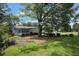 Home's backyard has mature trees and greenery surrounding a luscious lawn at 3835 Clearwater Dr, Atlanta, GA 30349