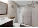 Renovated bathroom with brick style shower, sliding glass door, and modern vanity at 3835 Clearwater Dr, Atlanta, GA 30349