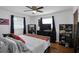 Bedroom featuring hardwood floors, a ceiling fan, and ample closet space at 3835 Clearwater Dr, Atlanta, GA 30349