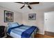 Bedroom with hardwood floors, a ceiling fan, and framed wall art at 3835 Clearwater Dr, Atlanta, GA 30349