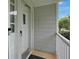 The light gray house has a storm door and a new door bell at 3835 Clearwater Dr, Atlanta, GA 30349