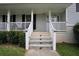 Traditional home with a welcoming front porch and brick stairs at 3835 Clearwater Dr, Atlanta, GA 30349