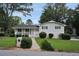 Charming home with an inviting front porch, manicured landscaping, and a well-kept lawn at 3835 Clearwater Dr, Atlanta, GA 30349