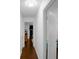 Hallway with an open doorway and hardwood floors throughout at 3835 Clearwater Dr, Atlanta, GA 30349