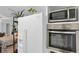 Bright kitchen featuring white appliances, stainless steel microwave and oven at 3835 Clearwater Dr, Atlanta, GA 30349
