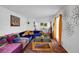 Bright living room featuring a colorful sectional sofa and vibrant decor at 3835 Clearwater Dr, Atlanta, GA 30349
