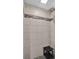 Shower with white tile walls, black pebble floor, and rain shower head at 3835 Clearwater Dr, Atlanta, GA 30349