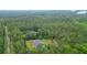 Aerial view showcasing the house and its surroundings, featuring lush greenery and a serene setting at 188 Macedonia Rd, White, GA 30184