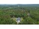 Aerial shot of property highlighting the expansive land, pool, and location surrounded by lush greenery at 188 Macedonia Rd, White, GA 30184