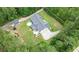 Aerial view showcases a spacious lawn, large driveway, and the home's layout within a wooded area at 188 Macedonia Rd, White, GA 30184