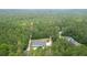 Aerial view of the property displaying lush surroundings, a long driveway, and ample greenery at 188 Macedonia Rd, White, GA 30184