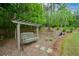 Relax on this backyard swing under a pergola and enjoy a peaceful, wooded view at 188 Macedonia Rd, White, GA 30184