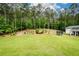 Spacious backyard with mature trees and a view of the outbuilding at 188 Macedonia Rd, White, GA 30184