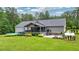 The beautiful backyard features a deck, patio, pool, greenhouse, and a lush green lawn at 188 Macedonia Rd, White, GA 30184