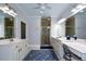 Bright bathroom features double sinks, a vanity, shower, and a blue decorative rug at 188 Macedonia Rd, White, GA 30184