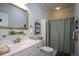 Bright bathroom featuring a vanity, large mirror, and shower with a curtain at 188 Macedonia Rd, White, GA 30184