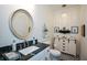 Charming powder room features black and white floors, granite countertop, and decorative mirror at 188 Macedonia Rd, White, GA 30184