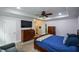 Cozy primary bedroom with a mounted TV, tray ceiling, and carpet flooring at 188 Macedonia Rd, White, GA 30184