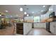 Open-concept kitchen boasts white cabinets, granite countertops, and an island with seating, connecting to the dining and living areas at 188 Macedonia Rd, White, GA 30184